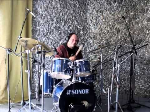 Recording drums by the stone wall